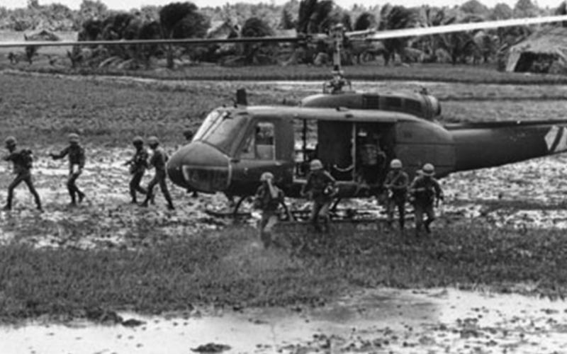 135th Iroquois “slick” helicopter unloading troops in Landing Zone.