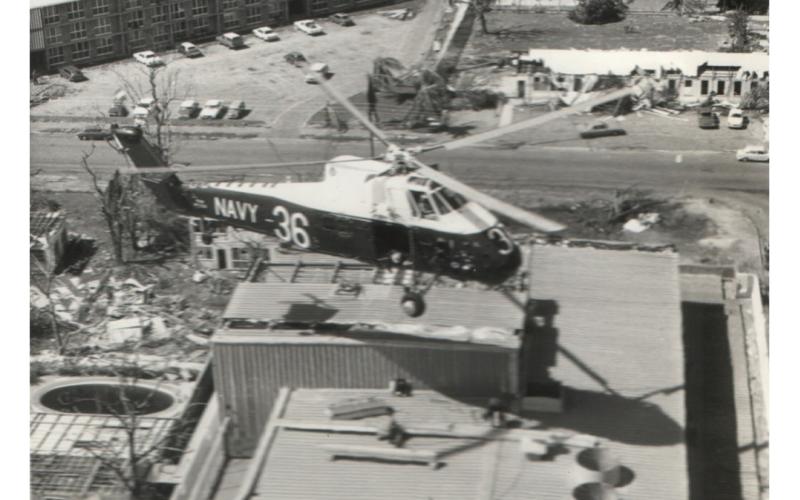 A Wessex helicopter from 817 Squadron hovers above the Travelodge building in Darwin.