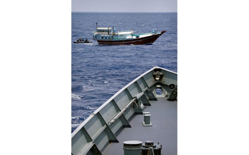HMAS Darwin's boarding party team, embarked on a rigid hull inflatable boat, approaches a suspicious dhow with the intention of boarding and searching for illegal narcotics, Middle East Area of Operation, May 2014.