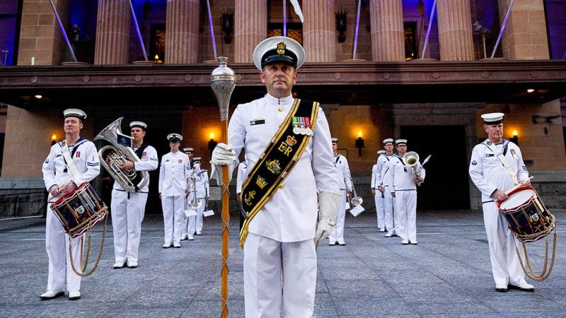 Chief Petty Officer Musician Simon Potter leads the South East Queensland Navy Band at the ceremonial sunset in Kings square