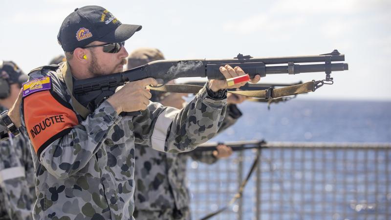 Seaman Boatswain Mate Jack Dimmack fires the Remington 870P Shotgun on the flight deck of HMAS Toowoomba.