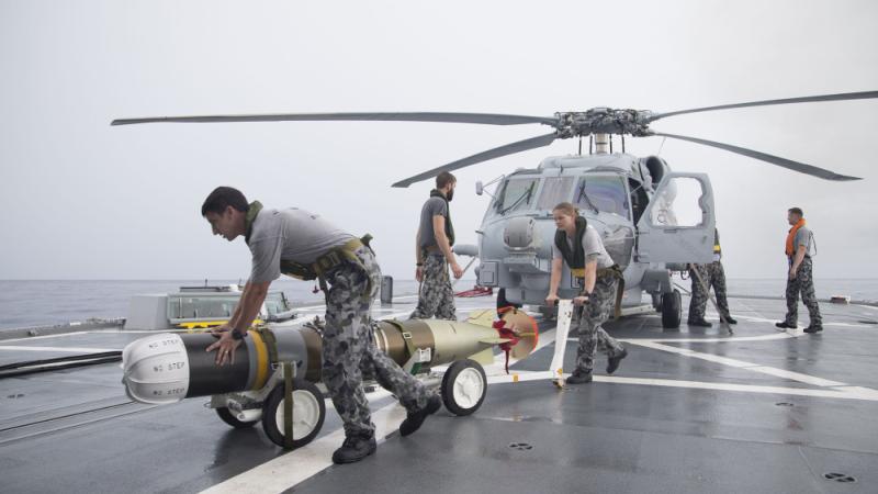 Wheeling a Mk54 torpedo off HMAS Parramatta's flight deck after it was removed from the embarked MH60-R Seahawk Helicopter.
