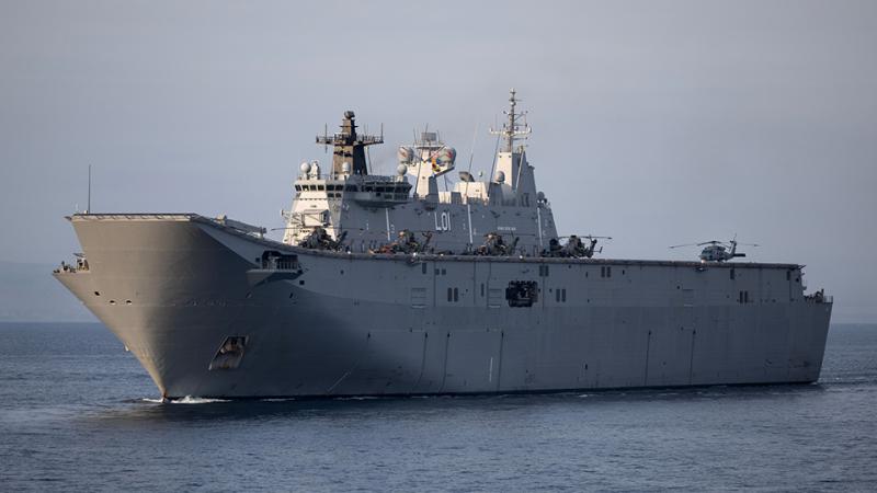HMAS Adelaide sailing in open water.