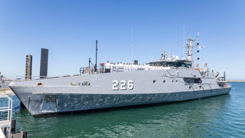 HMAS Cape Hawke moored beside a dock.